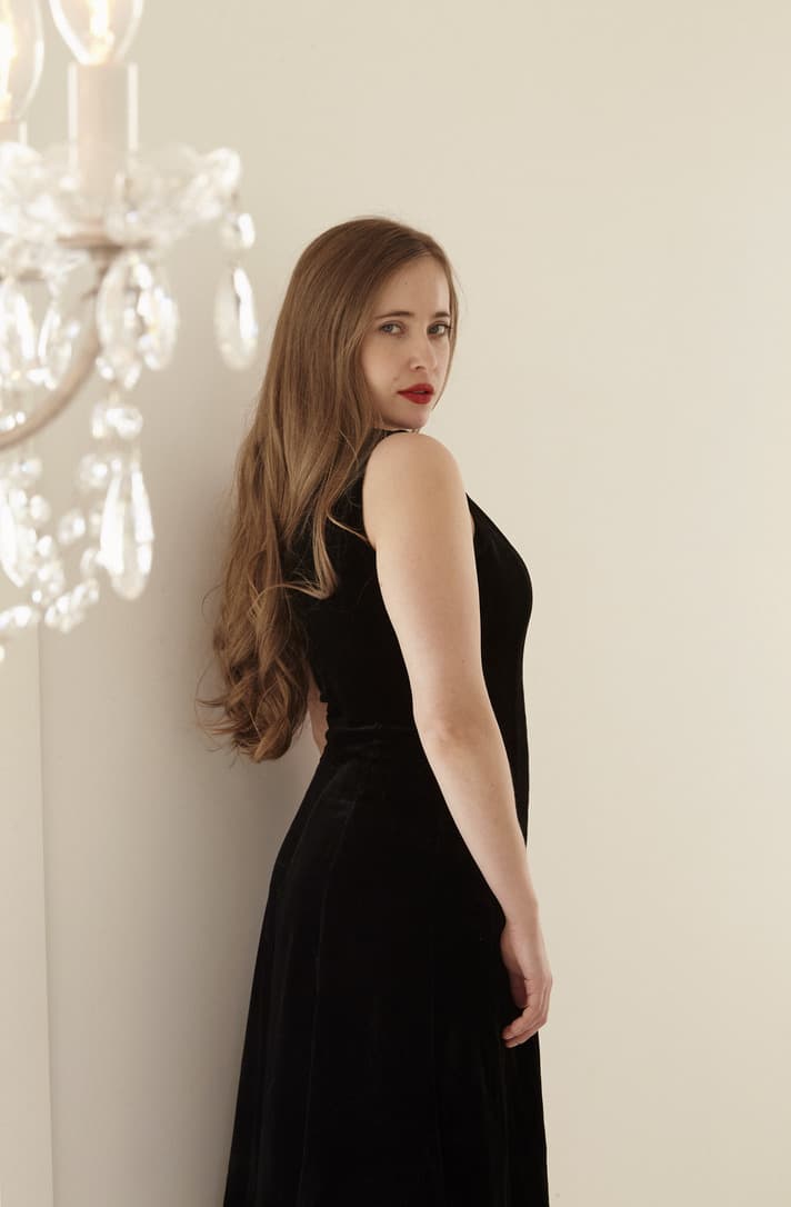 Maisie Hayden in a black velvet dress